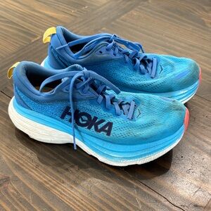 Hoka Cushioned Blue Running Shoes with Yellow Heel Tab and Coral Toe